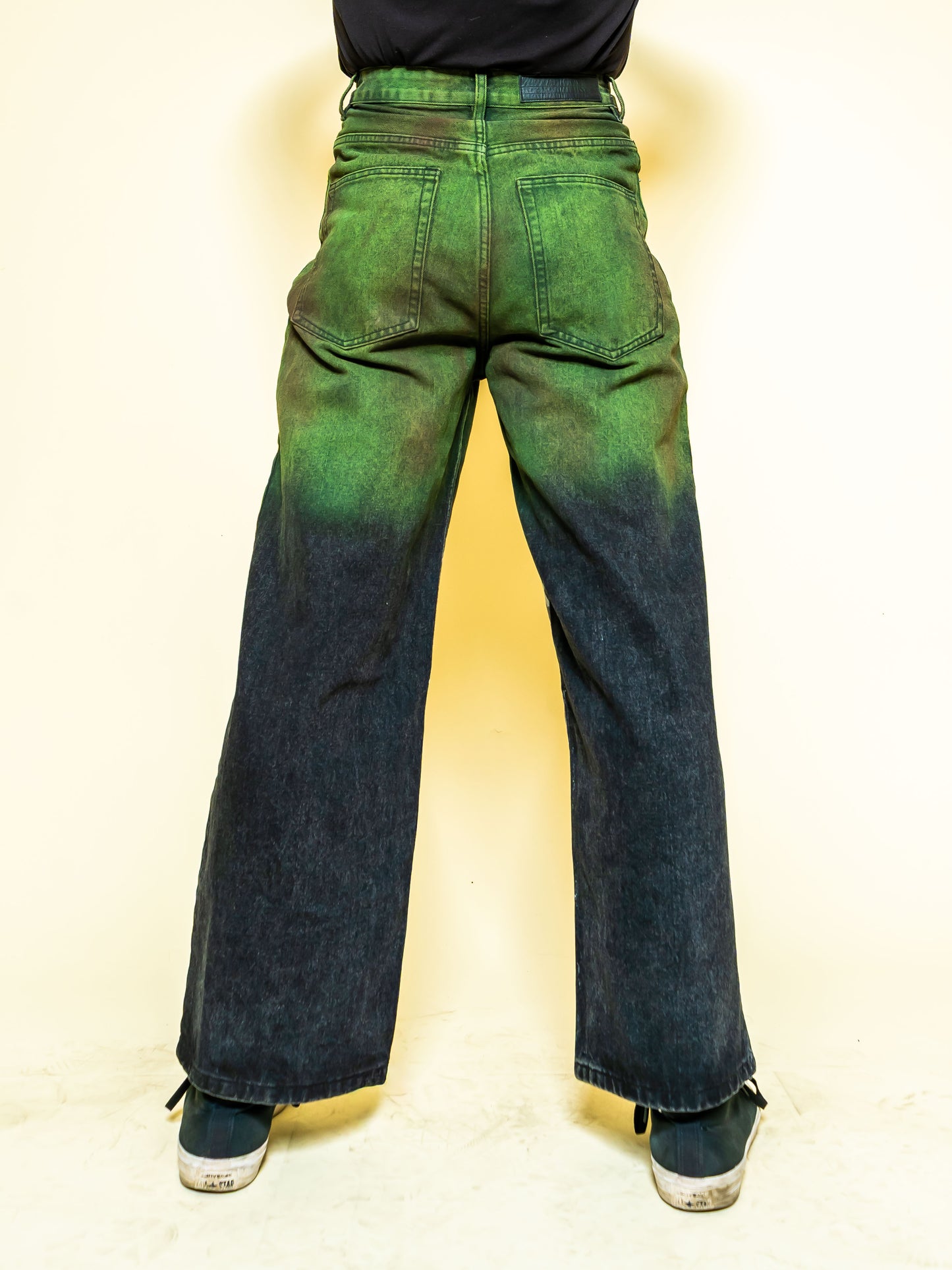 The PAiNtR paint splatter wide leg denim jeans on model | F.A.M.E. X streetwear