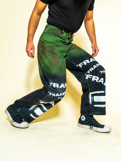 The PAiNtR paint splatter wide leg denim jeans on model | F.A.M.E. X streetwear