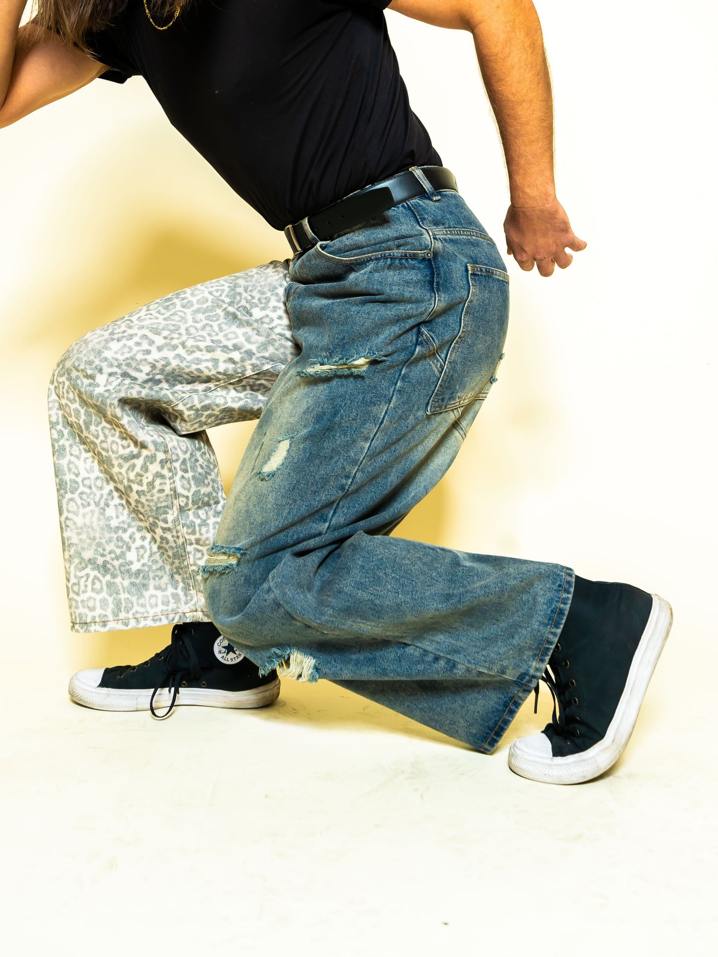 The PAiNtR paint splatter wide leg denim jeans on model | F.A.M.E. X streetwear