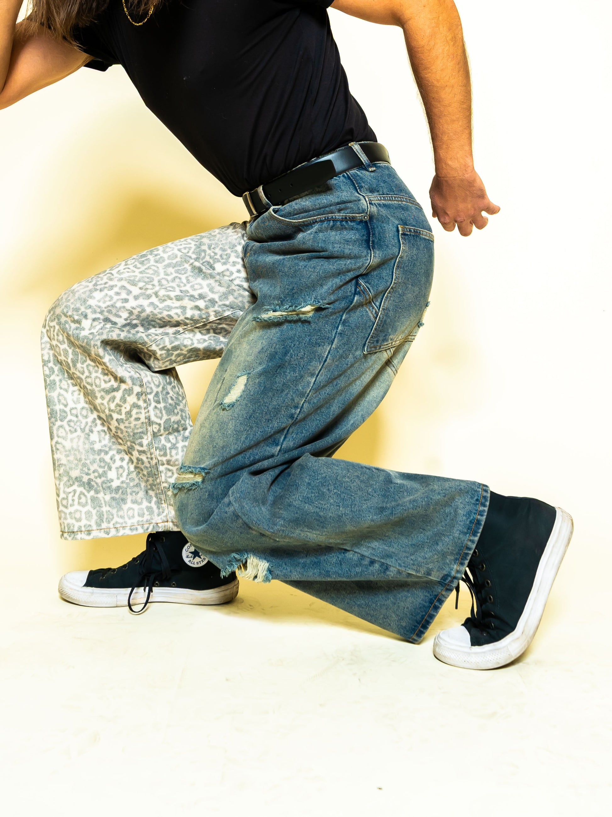 The PAiNtR paint splatter wide leg denim jeans on model | F.A.M.E. X streetwear