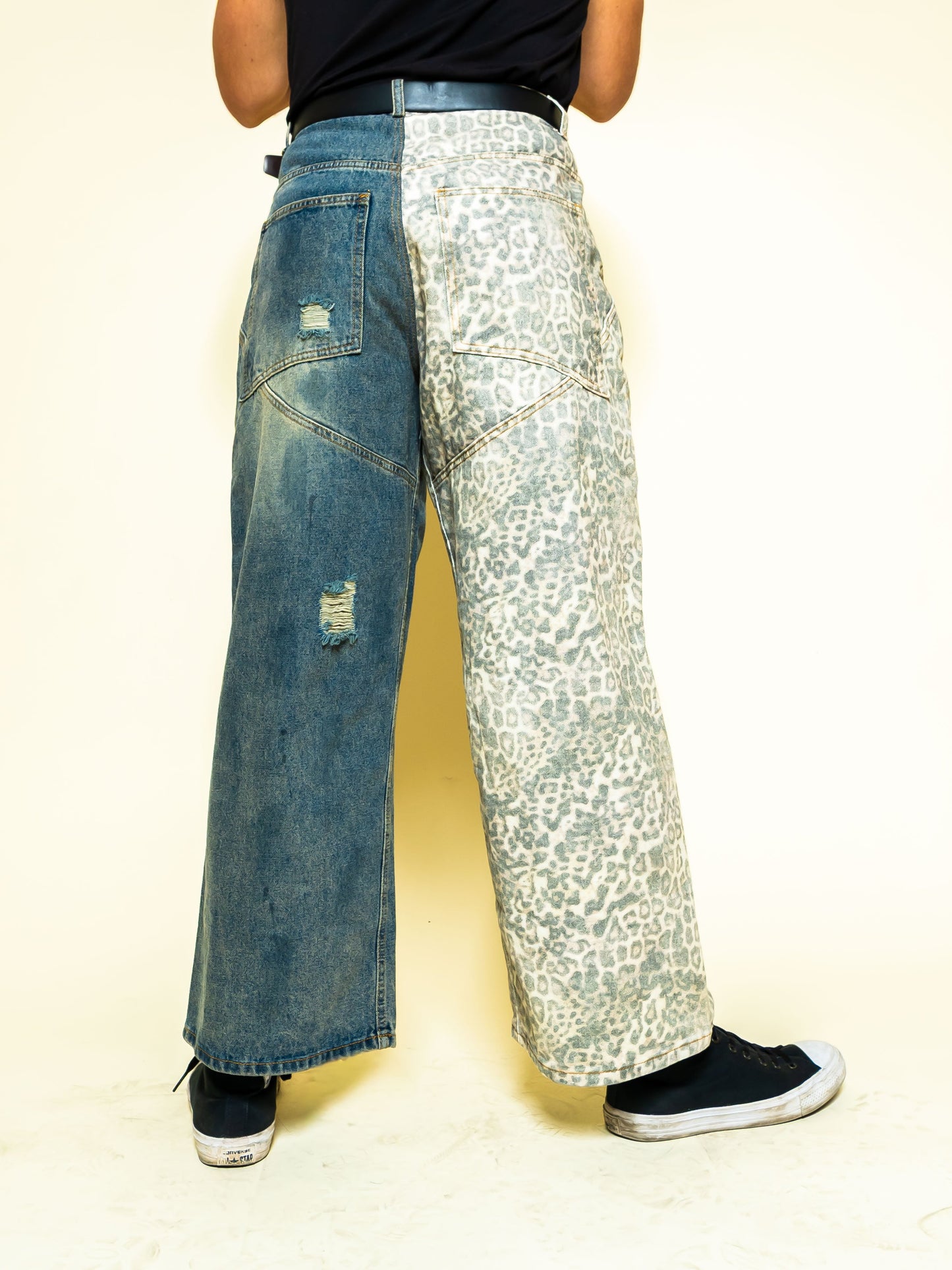 The PAiNtR paint splatter wide leg denim jeans on model | F.A.M.E. X streetwear